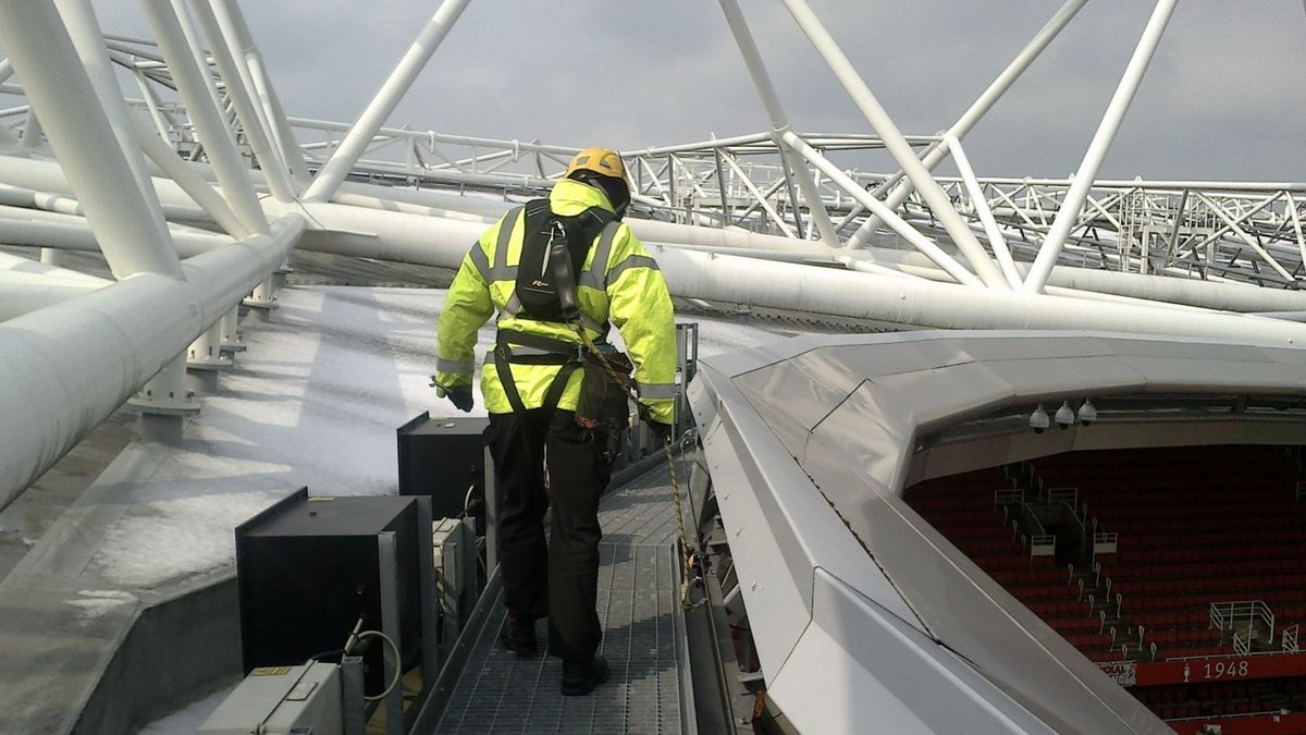 Worker with harness at stadium