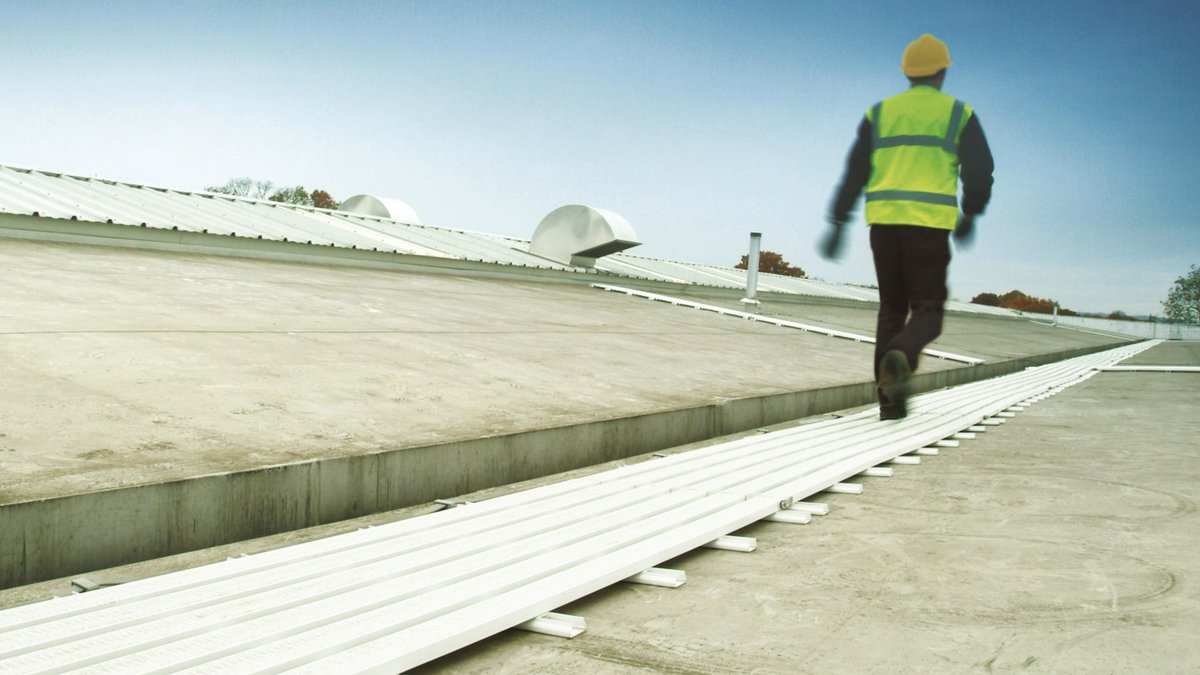 Worker on WalkSafe rooftop walkway