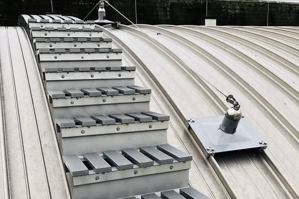 Fall protection system components on metal roof