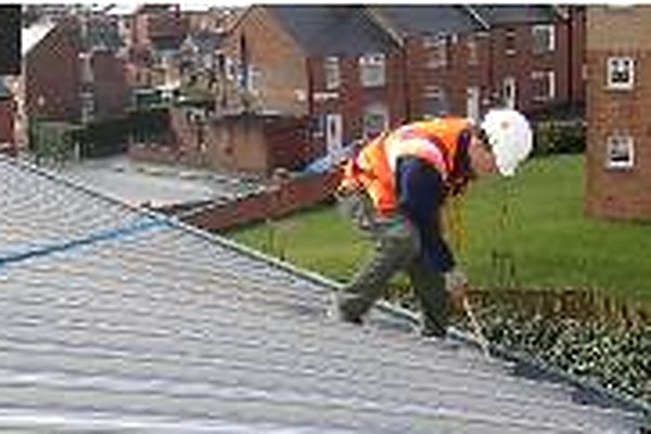 Pinnacle operative working on sloping roof maintenance